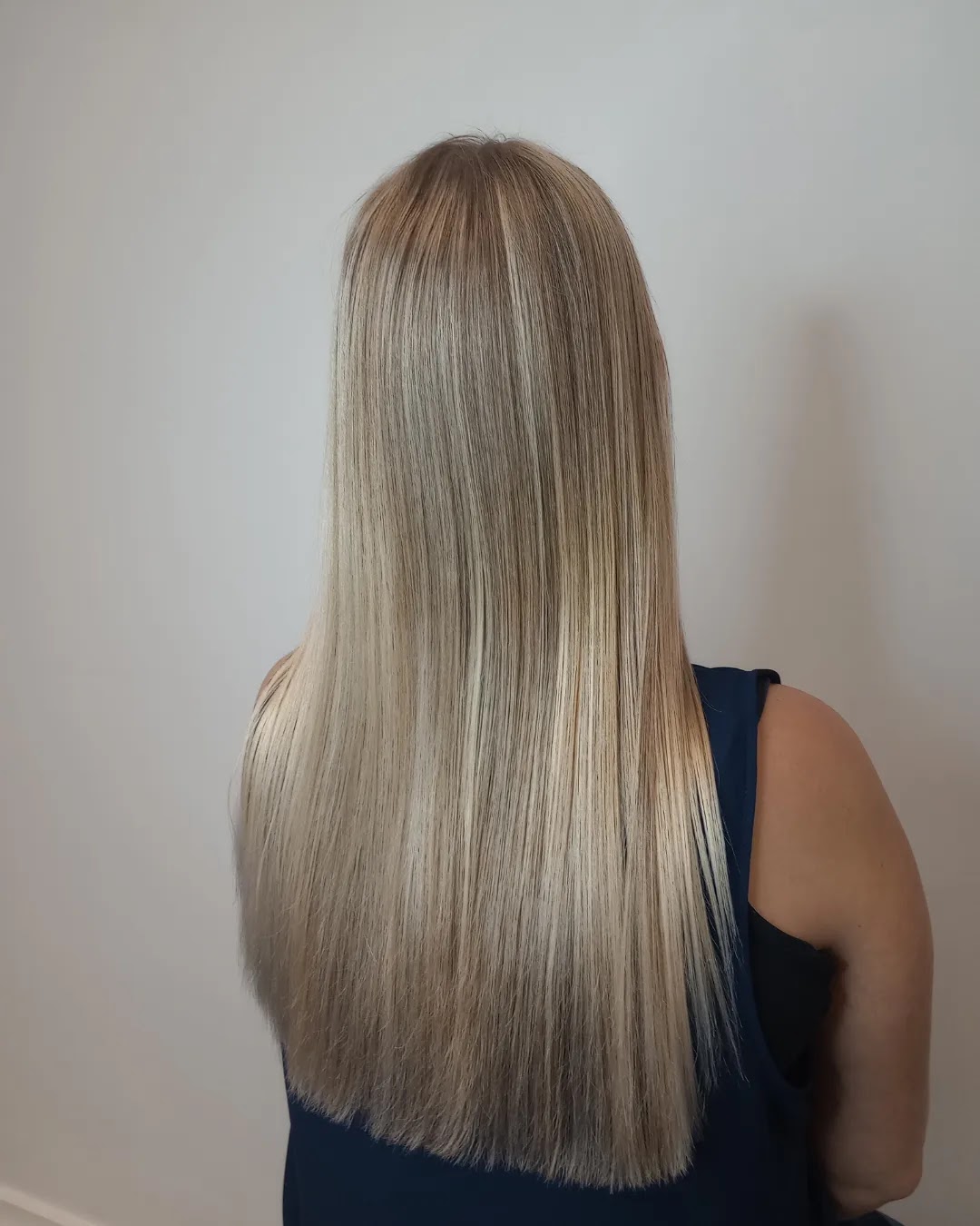 Lang, steil blond haar met highlights, van achteren gefotografeerd